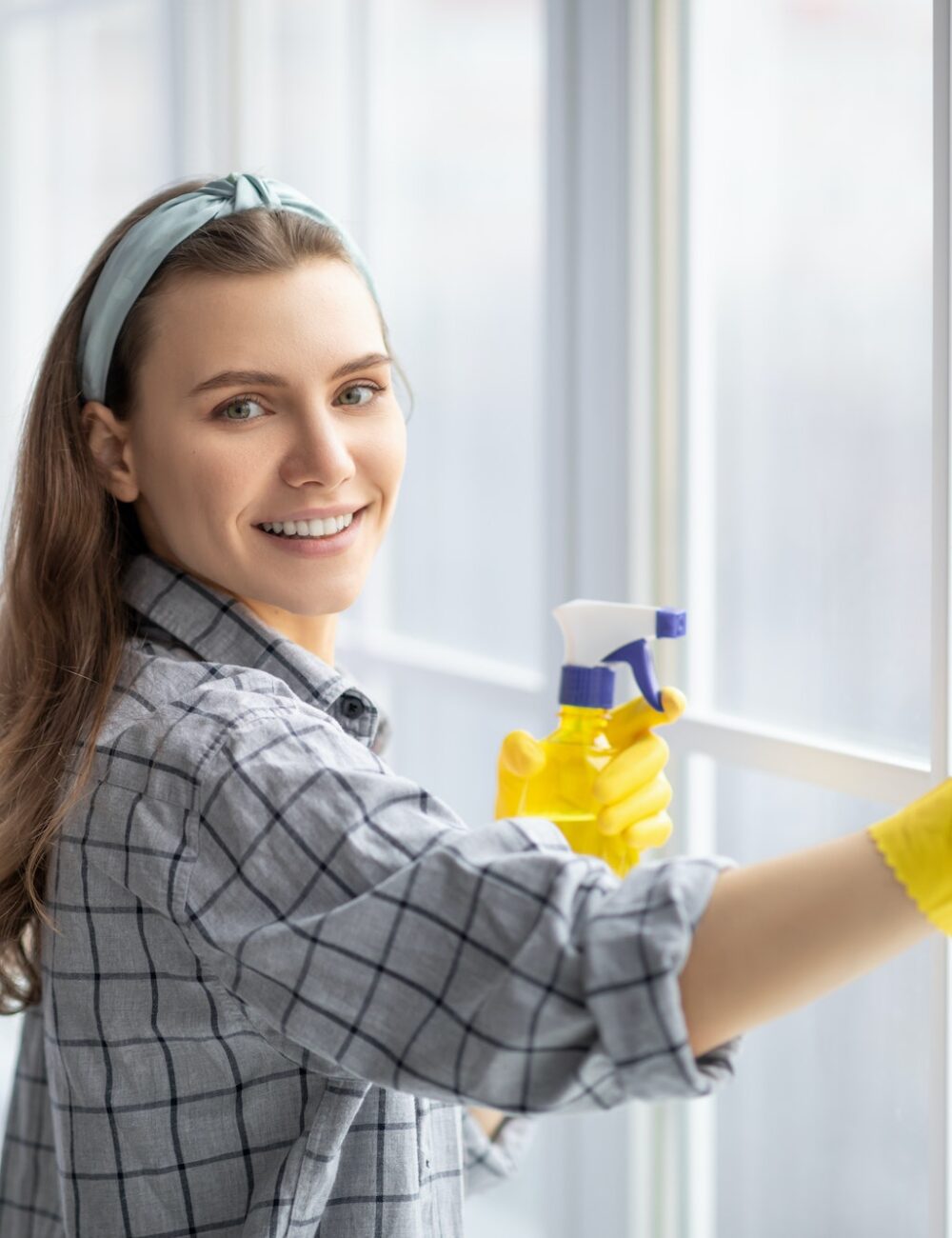 smiling-young-woman-with-detergent-and-rag-cleaning-window-glass-professional-sanitary-service.jpg